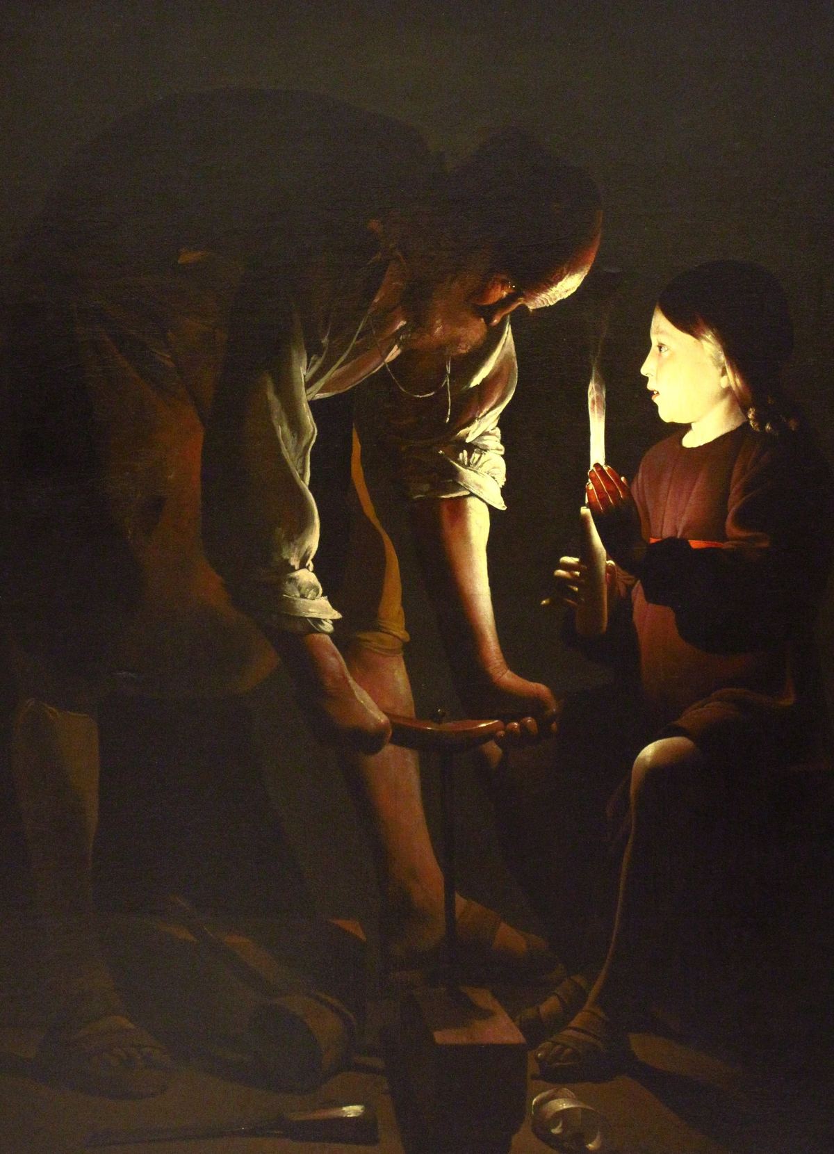 São José carpinteiro e o Menino Jesus à luz de uma vela, pintura de Georges de La Tour